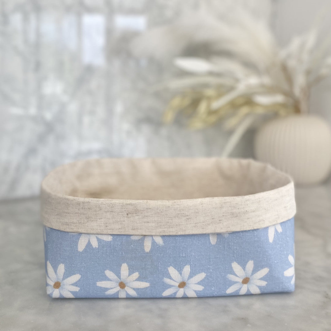Gift Box NZ | New Zealand made products | Small gift boxes NZ | Gift in New Zealand |  A large size gift box jam packed with handmade products, all packaged in a pretty blue daisy fabric box. Leaf shaped trinket tray in white. Large white soy wax blend Home candle. Set of two produce bags.