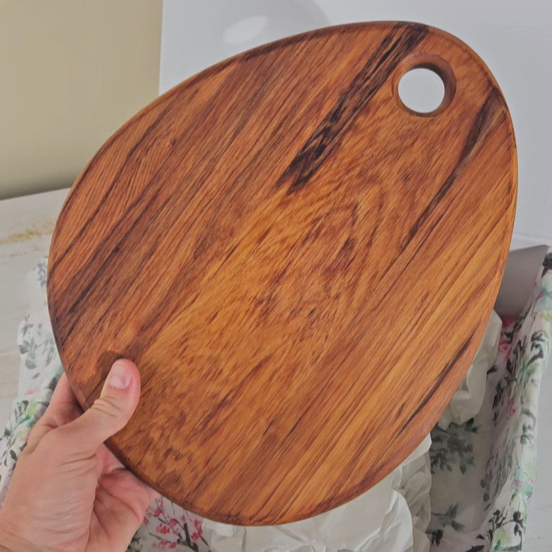 Beautifully handcrafted oval wooden cheese board. Perfect for serving cheese and crackers. Stylish and practical for any occasion.