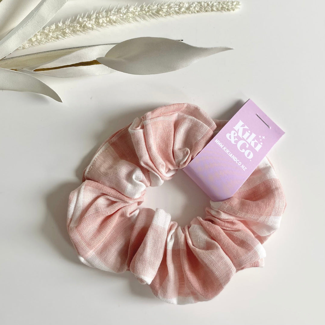 Gift Box NZ | New Zealand made products | Small gift boxes NZ | Gift in New Zealand |  Pink and white gingham scrunchie handmade by Kiki & Co. Crafted from high-quality materials, this scrunchie is made from a soft linen fabric.