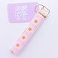 Gift Box NZ | New Zealand made products | Shop handmade pink daisy keychain, perfect to keep hands free on the go. Handcrafted keychain functional & stylish, designed to fit easily over wrist. Add it to a gift box or purchase individually. Order now & enjoy the convenience & style of these fabulous keychains!