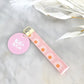 Gift Box NZ | New Zealand made products | Shop handmade pink daisy keychain, perfect to keep hands free on the go. Handcrafted keychain functional & stylish, designed to fit easily over wrist. Add it to a gift box or purchase individually. Order now & enjoy the convenience & style of these fabulous keychains!