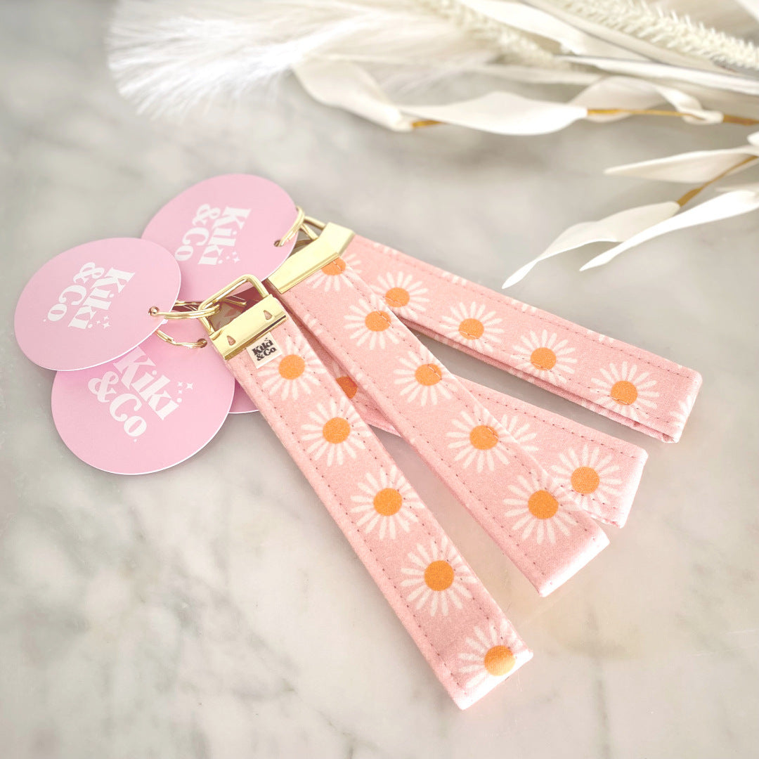 Gift Box NZ | New Zealand made products | Shop handmade pink daisy keychain, perfect to keep hands free on the go. Handcrafted keychain functional & stylish, designed to fit easily over wrist. Add it to a gift box or purchase individually. Order now & enjoy the convenience & style of these fabulous keychains!
